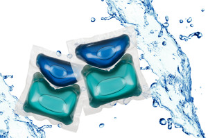 Gel laundry capsules in water splash other white background